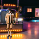 Singer Bad Bunny poses in front of his black big rig.